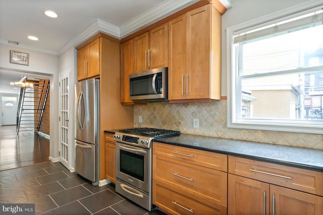 816 S Milton Ave, Baltimore, MD 21224 - kitchen featuring appliances with stainless steel finishes, plenty of natural light, brown cabinets, crown molding, and tasteful backsplash