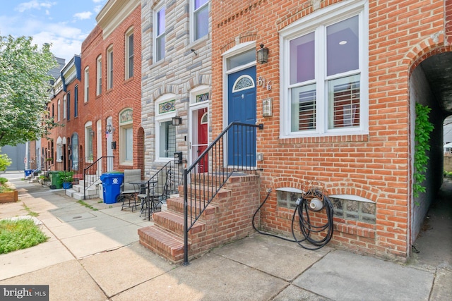 816 S Milton Ave, Baltimore, MD 21224 - doorway to property featuring brick siding
