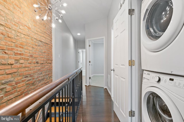 816 S Milton Ave, Baltimore, MD 21224 - laundry area with brick wall, stacked washer / drying machine, a chandelier, dark wood-style floors, and recessed lighting