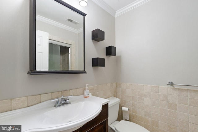 816 S Milton Ave, Baltimore, MD 21224 - half bathroom featuring toilet, vanity, tile walls, crown molding, and wainscoting