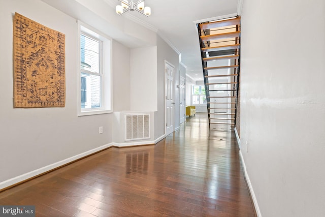 816 S Milton Ave, Baltimore, MD 21224 - hall with crown molding, baseboards, hardwood / wood-style flooring, and a chandelier