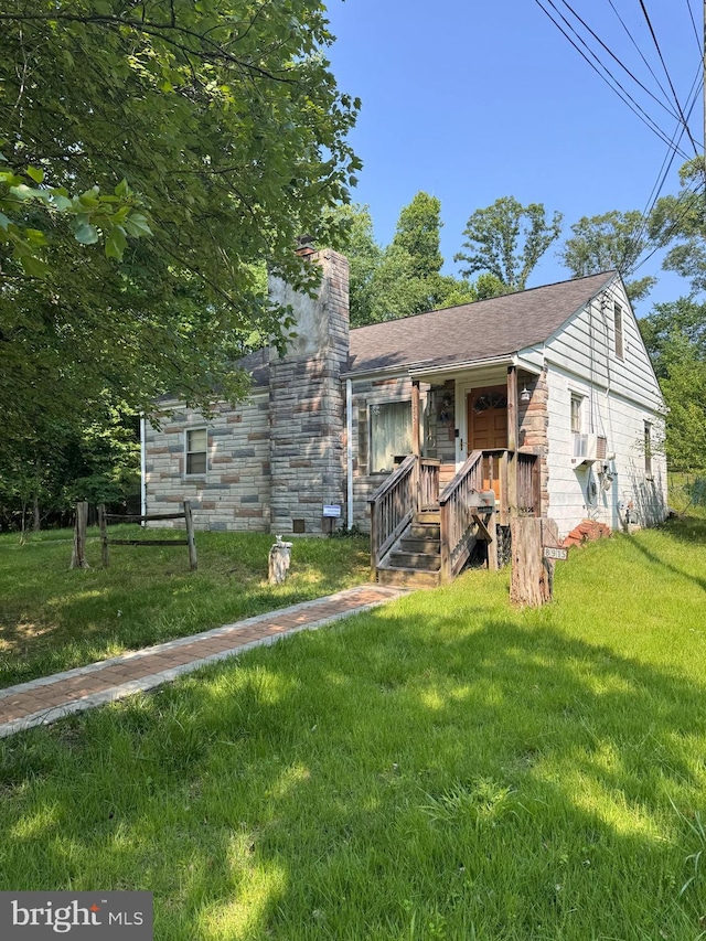 8915 56th Ave, Berwyn Heights, MD 20740 - view of front of home featuring a chimney, a front yard, stone siding, and cooling unit