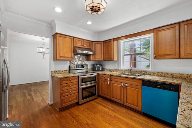 8321 Terra Grande Ave, Springfield, VA 22153 - kitchen featuring appliances with stainless steel finishes, under cabinet range hood, a sink, brown cabinetry, and crown molding