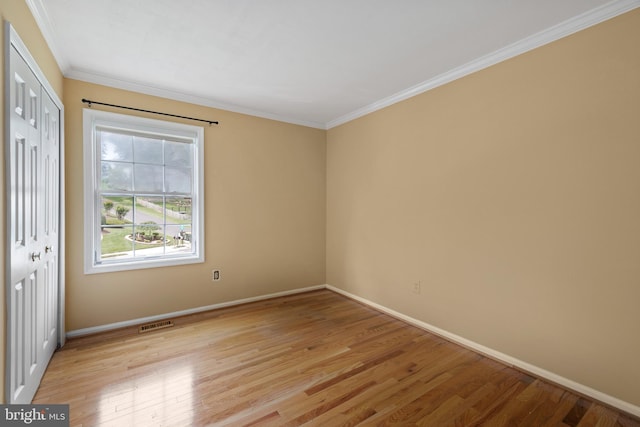 8321 Terra Grande Ave, Springfield, VA 22153 - unfurnished bedroom featuring baseboards, light wood finished floors, a closet, and crown molding