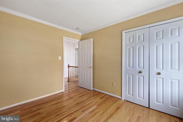 8321 Terra Grande Ave, Springfield, VA 22153 - unfurnished bedroom with light wood-style floors, baseboards, crown molding, and a closet