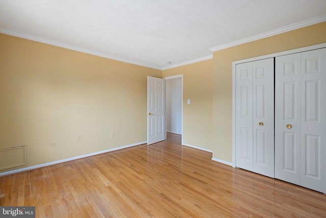 8321 Terra Grande Ave, Springfield, VA 22153 - unfurnished bedroom with light wood-type flooring, baseboards, crown molding, and a closet