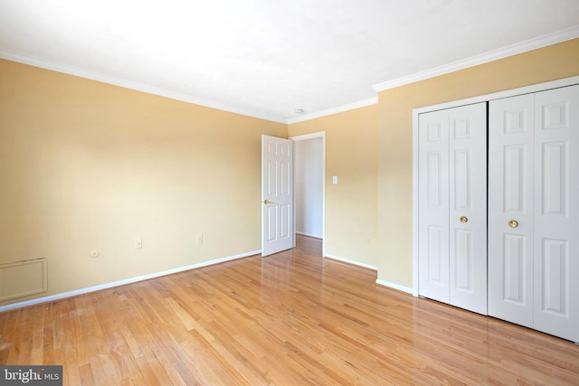 8321 Terra Grande Ave, Springfield, VA 22153 - unfurnished bedroom with light wood finished floors, baseboards, crown molding, and a closet
