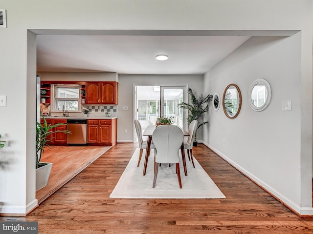 2411 Ruth Ave, Sparrows Point, MD 21219 - dining area featuring plenty of natural light, light wood finished floors, and baseboards