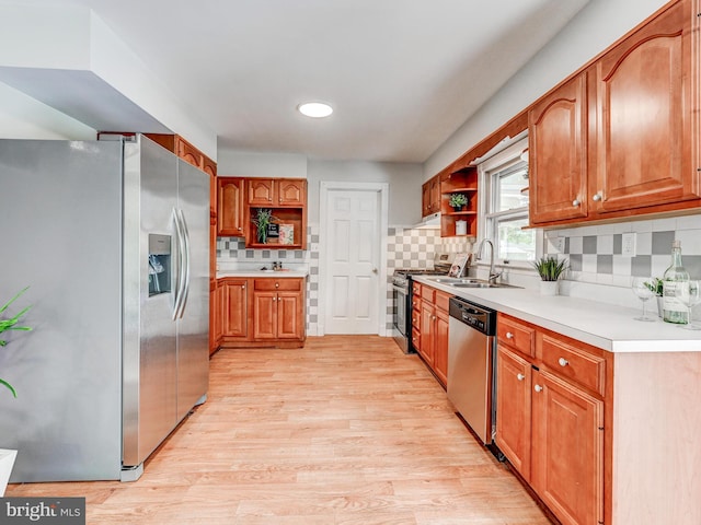 2411 Ruth Ave, Sparrows Point, MD 21219 - kitchen with appliances with stainless steel finishes, open shelves, light wood-type flooring, and brown cabinets