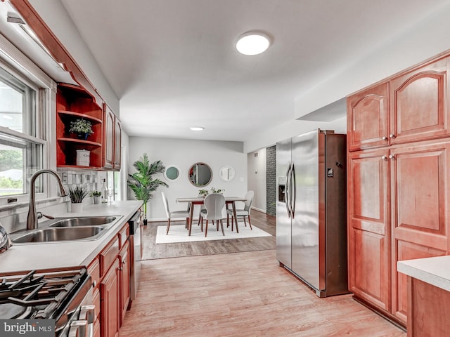 2411 Ruth Ave, Sparrows Point, MD 21219 - kitchen featuring stainless steel appliances, a sink, light countertops, light wood-style flooring, and tasteful backsplash