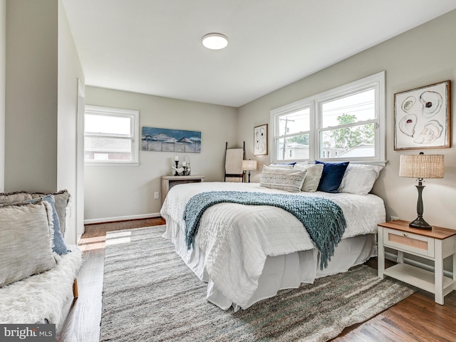 2411 Ruth Ave, Sparrows Point, MD 21219 - bedroom featuring multiple windows, wood finished floors, and baseboards