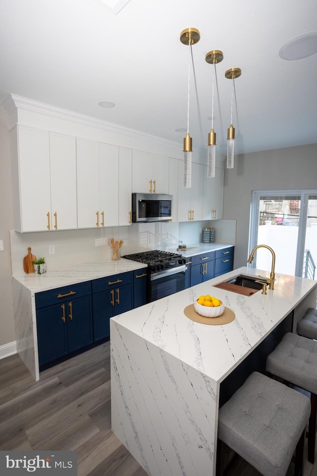 2127 Sigel St, Philadelphia, PA 19145 - kitchen featuring blue cabinets, stainless steel microwave, black gas range, and a sink