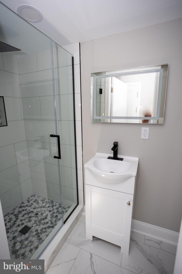 2127 Sigel St, Philadelphia, PA 19145 - full bath with a stall shower, marble look tiles, vanity, and baseboards