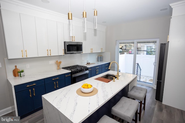 2127 Sigel St, Philadelphia, PA 19145 - kitchen featuring blue cabinets, stainless steel microwave, black range with gas stovetop, a sink, and freestanding refrigerator