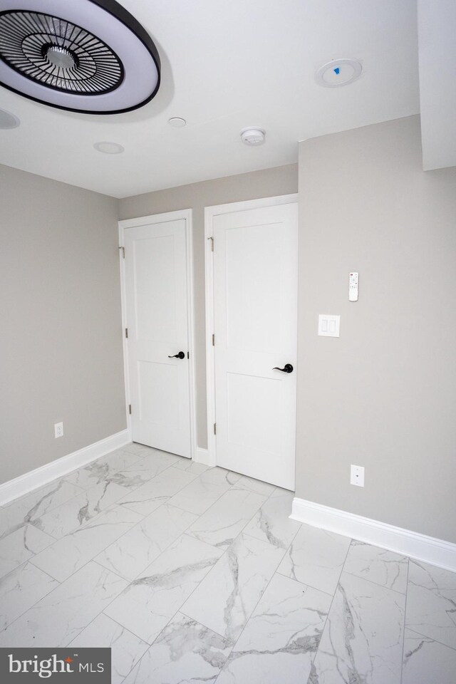 2127 Sigel St, Philadelphia, PA 19145 - spare room featuring baseboards, light marble finish flooring, and a smoke detector