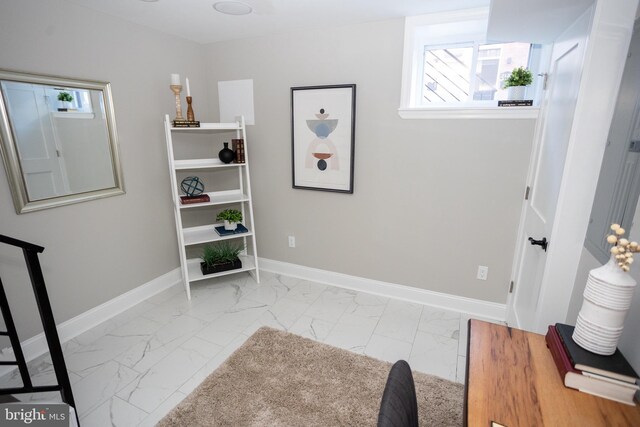 2127 Sigel St, Philadelphia, PA 19145 - living area featuring marble finish flooring, healthy amount of natural light, and baseboards
