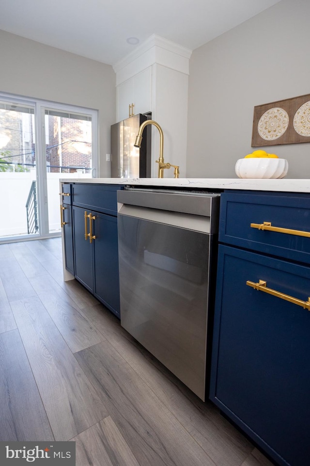 2127 Sigel St, Philadelphia, PA 19145 - kitchen with blue cabinets, dishwasher, wood finished floors, and light countertops