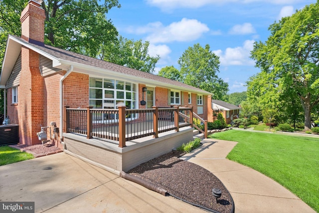 5634 Inverchapel Rd, Springfield, VA 22151 - ranch-style home with a front lawn, a chimney, brick siding, and a wooden deck