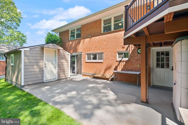 5634 Inverchapel Rd, Springfield, VA 22151 - back of house featuring a patio, brick siding, and a balcony