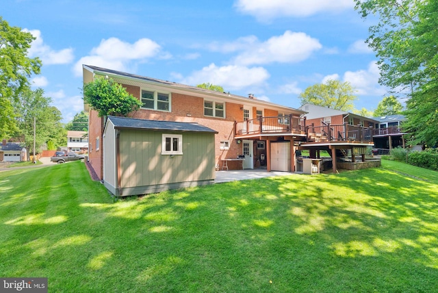 5634 Inverchapel Rd, Springfield, VA 22151 - rear view of house featuring a patio, a wooden deck, a yard, and brick siding