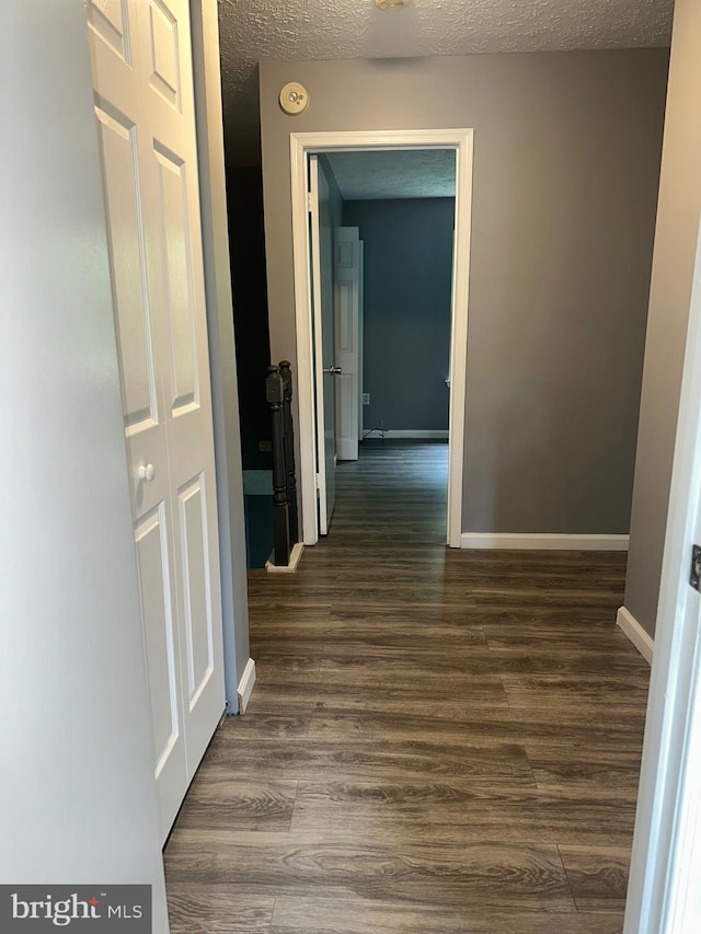 11429 Honeysuckle Ct Unit 3-3, Upper Marlboro, MD 20774 - corridor with dark wood-style flooring, a textured ceiling, and baseboards