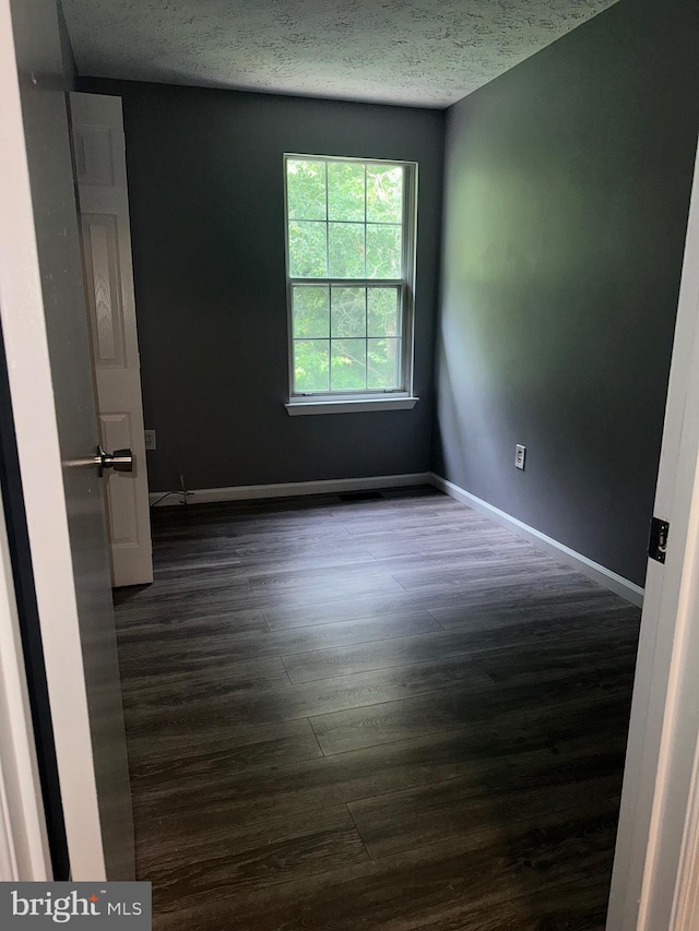 11429 Honeysuckle Ct Unit 3-3, Upper Marlboro, MD 20774 - spare room with dark wood-style floors, baseboards, and a textured ceiling