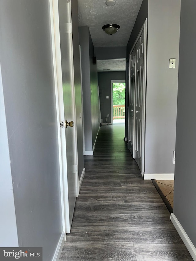 11429 Honeysuckle Ct Unit 3-3, Upper Marlboro, MD 20774 - hallway featuring dark wood-style floors, baseboards, and a textured ceiling