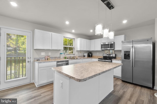 213 Pickett St, Taneytown, MD 21787 - kitchen with stainless steel appliances, light countertops, white cabinets, recessed lighting, and a center island