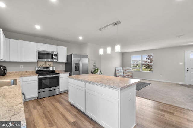 213 Pickett St, Taneytown, MD 21787 - kitchen with appliances with stainless steel finishes, light countertops, white cabinets, a center island, and recessed lighting