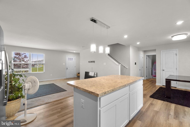 213 Pickett St, Taneytown, MD 21787 - kitchen with light wood-style flooring, a center island, recessed lighting, white cabinetry, and open floor plan