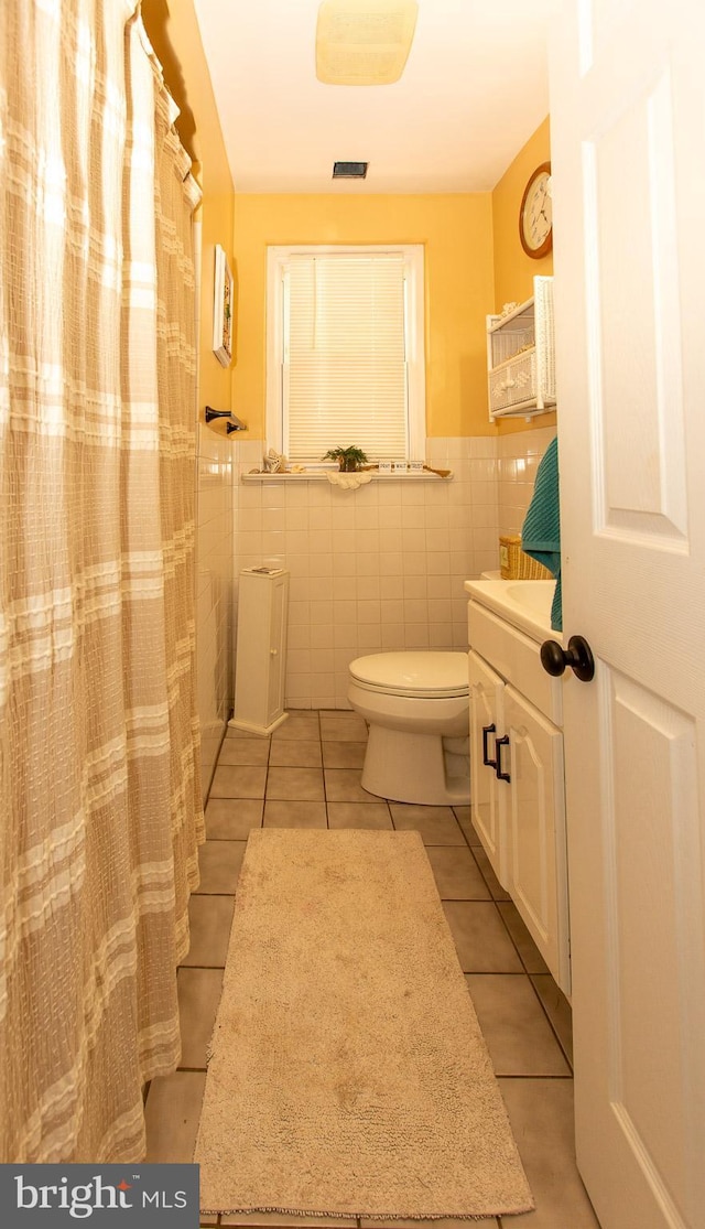 312 E 7th Ave, Trappe, PA 19426 - bathroom with toilet, tile walls, tile patterned floors, vanity, and wainscoting