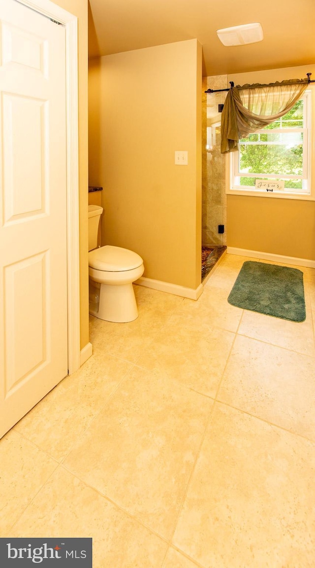 312 E 7th Ave, Trappe, PA 19426 - bathroom with toilet, tiled shower, tile patterned floors, and baseboards