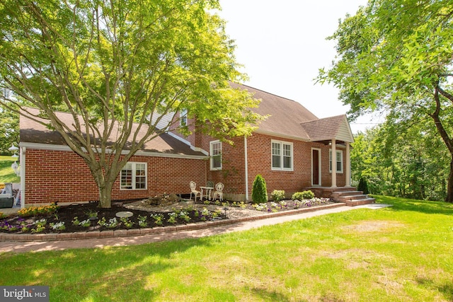 312 E 7th Ave, Trappe, PA 19426 - view of front of house with brick siding, a front lawn, and a shingled roof