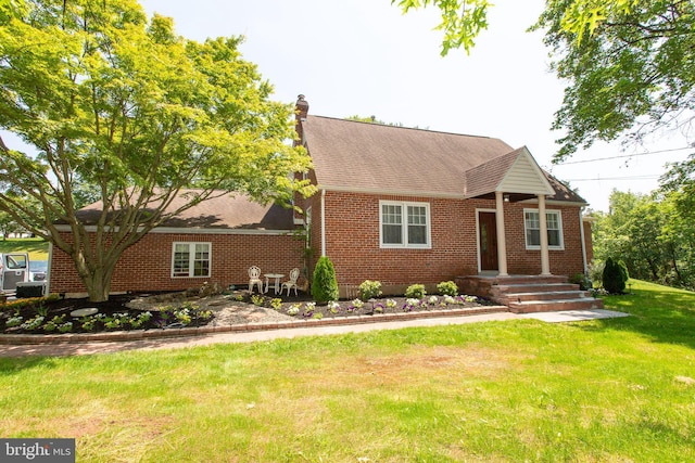 312 E 7th Ave, Trappe, PA 19426 - view of front facade featuring brick siding, a front lawn, roof with shingles, and a chimney