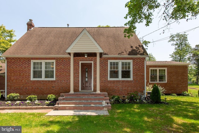 312 E 7th Ave, Trappe, PA 19426 - view of front of property with brick siding, a chimney, a front lawn, and a shingled roof