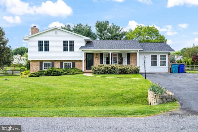7902 Juniper Dr, Frederick, MD 21702 - tri-level home featuring brick siding, a chimney, and driveway