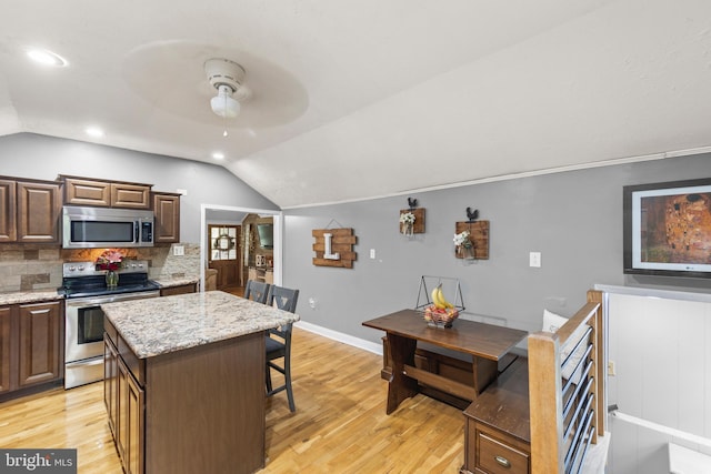 171 Sinking Spring Ln, Gore, VA 22637 - kitchen with stainless steel appliances, lofted ceiling, ceiling fan, light wood finished floors, and tasteful backsplash