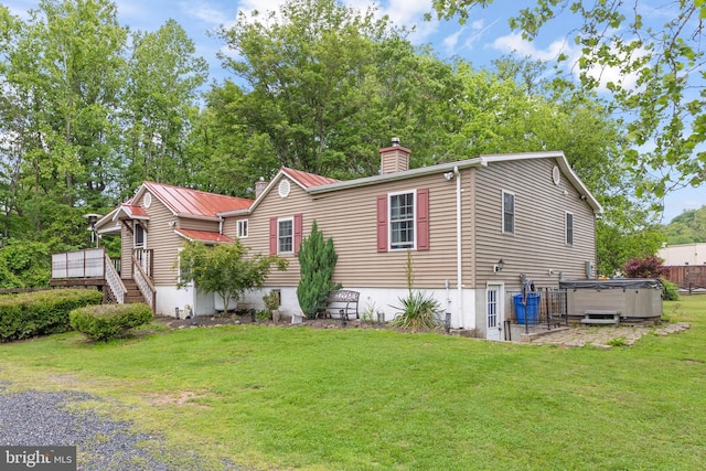 171 Sinking Spring Ln, Gore, VA 22637 - view of side of home with a hot tub, a chimney, a lawn, and a wooden deck