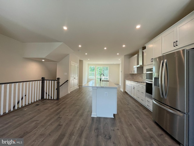 13206 Nixon Ln, Woodbridge, VA 22193 - kitchen featuring stainless steel appliances, a sink, white cabinets, wall chimney exhaust hood, and recessed lighting