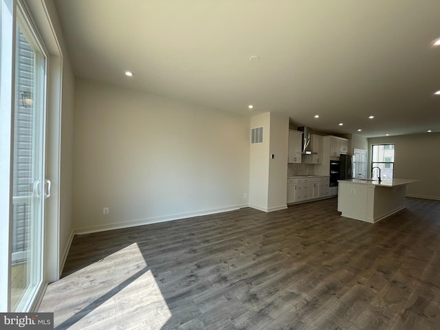 13206 Nixon Ln, Woodbridge, VA 22193 - unfurnished living room featuring baseboards, recessed lighting, and dark wood-style floors