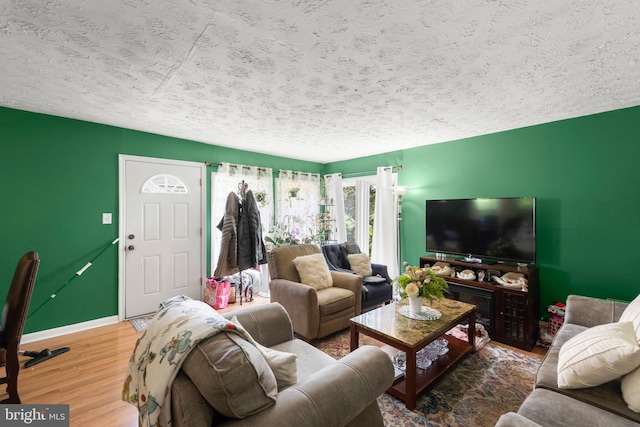 320 Lee St, Front Royal, VA 22630 - living room featuring a textured ceiling, wood finished floors, and baseboards