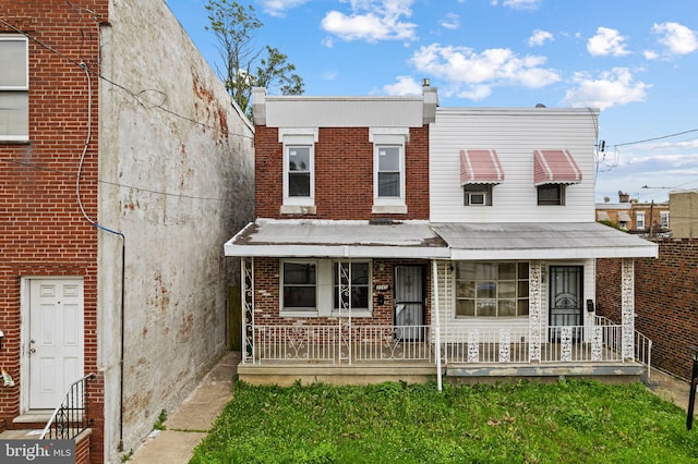 3545 Emerald St, Philadelphia, PA 19134 - view of property featuring brick siding and a porch