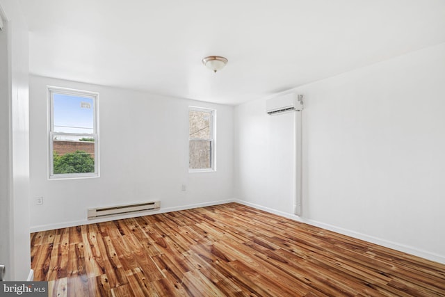 3545 Emerald St, Philadelphia, PA 19134 - empty room featuring a baseboard heating unit, a wall mounted AC, wood finished floors, and baseboards