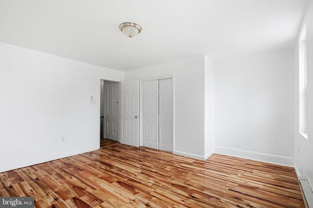 3545 Emerald St, Philadelphia, PA 19134 - unfurnished bedroom with wood finished floors, a closet, and baseboards