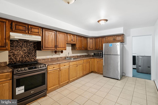 3545 Emerald St, Philadelphia, PA 19134 - kitchen with appliances with stainless steel finishes, under cabinet range hood, a sink, and dark countertops