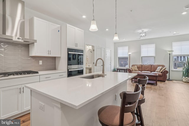 45922 Swallow Ter, Sterling, VA 20165 - kitchen featuring wall chimney exhaust hood, stainless steel appliances, plenty of natural light, light countertops, and recessed lighting