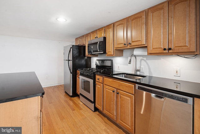 810 N Hancock St Unit 2, Philadelphia, PA 19123 - kitchen featuring appliances with stainless steel finishes, dark countertops, light wood-type flooring, brown cabinetry, and recessed lighting