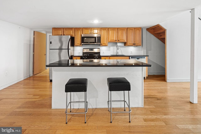 810 N Hancock St Unit 2, Philadelphia, PA 19123 - kitchen with stainless steel appliances, light wood finished floors, a kitchen bar, and recessed lighting