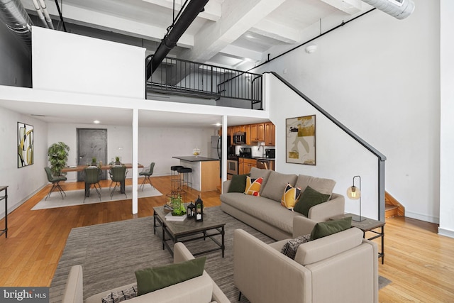810 N Hancock St Unit 2, Philadelphia, PA 19123 - living area with stairway, a towering ceiling, light wood finished floors, and beam ceiling
