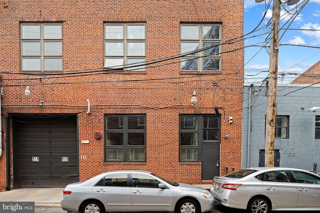 810 N Hancock St Unit 2, Philadelphia, PA 19123 - view of front of property featuring brick siding and a garage